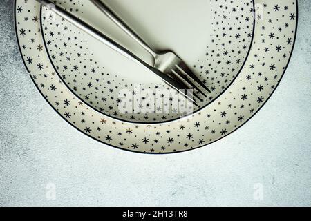 Minimalistic table setting for Christmas dinner on white concrete table Stock Photo