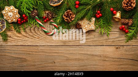 Fir tree branches and christmas decorations on wooden background. Stock Photo