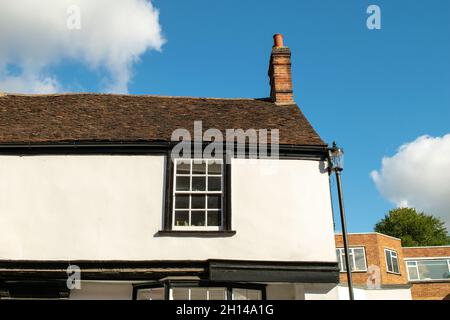Top of Tudor style timber framed cottage next to lamp post at Saffron Walden, England Stock Photo