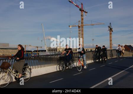 Cyclists cross Inderhavnsbroen (The Inner Harbour Bridge), completed 2016, Copenhagen, Denmark, Scandinavia, October 2021