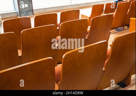 Rear of row brown theatre seats in auditorium hall Stock Photo