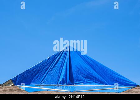 Blue tarp protecting hurricane damaged roof Stock Photo