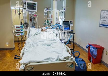 Miami Florida,hospital medical center centre ICU,intensive care unit patient,Hispanic adult man male bed life support heart attack equipment