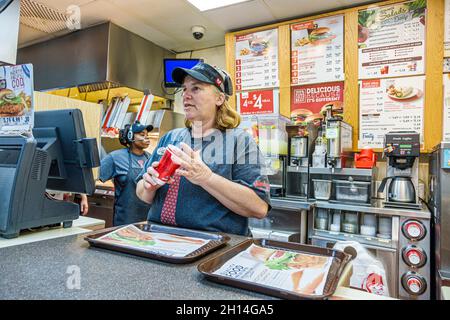 Fort Ft. Myers Florida,Wendy's fast food,interior inside,restaurant preparing taking counter woman female working worker employee Stock Photo