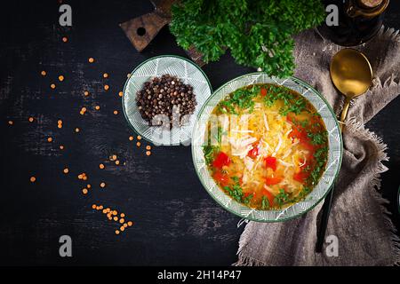 Chicken soup with red lentils and paprika. Traditional Mediterranean food. Healthy food. Top view, banner, above Stock Photo