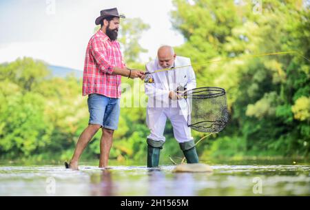 new skills. hobby and recreation. Success. Fishermen. successful catch. fisher celebrate retirement. good production. retired businessman. male Stock Photo