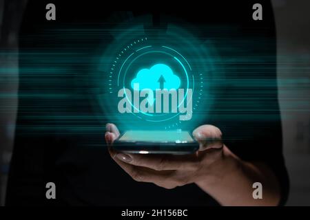 Cloud service concept with file storage and sharing over hand with icon and futuristic graphs Stock Photo
