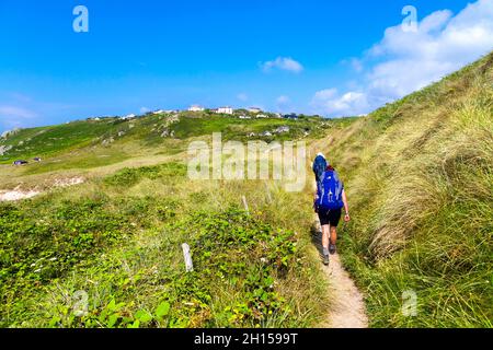 Hikers walking along the South West Coast Path near Gwynver Beach, Sennen, Coranwall, UK Stock Photo