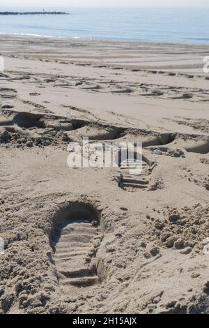 Shoe prints in the sand on a beach of the Mediterranean Sea Stock Photo