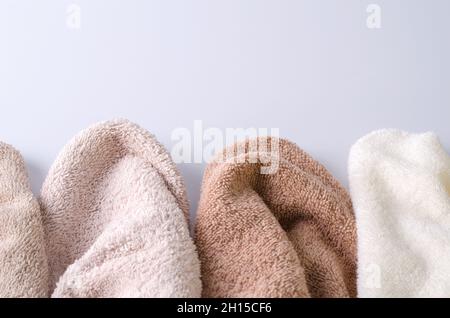 Cotton towels of pastel color on a light background. Background for demonstration of cosmetics for body, hair, face care, selective background, copyin Stock Photo