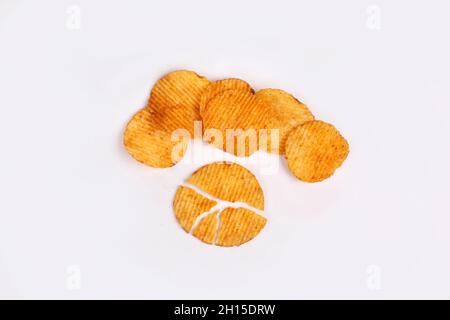 Potato chips falling into glass bowl isolated on white background with clipping path, flying potato crisps Stock Photo