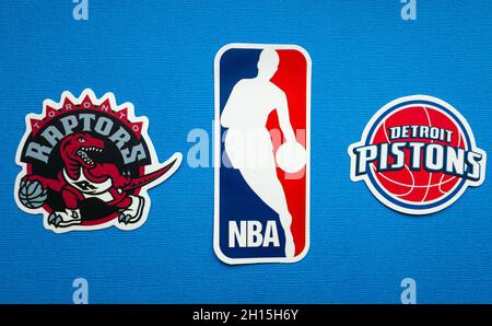 October 1, 2021, Springfield, USA, Emblems of the Toronto Raptors and Detroit Pistons basketball teams on a blue background. Stock Photo