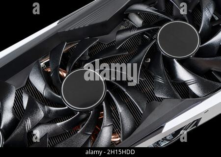 Video card with fan. Gaming graphics card for video games and cryptocurrency mining. Game video card isolated on black background. Electronic device, Stock Photo