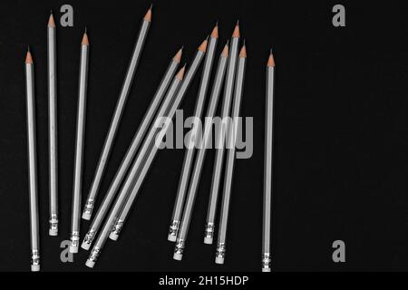 many gray pencils close-up against a black background, top view Stock Photo