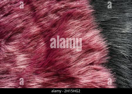 Fluffy warming plum-coloured and black fake furs. Stock Photo