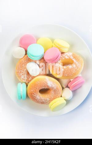 Different sweets isolated on white background, Doughnuts, macarons top view, unhealthy and candy concept Stock Photo