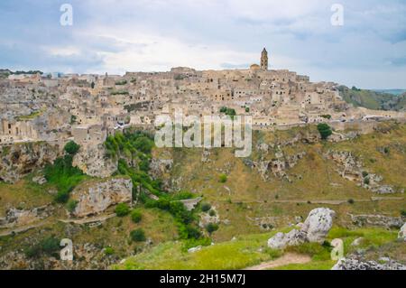 Watercolor drawing of Matera panoramic view of historical centre Sasso Caveoso old ancient town Sassi di Matera with cave rock houses with dramatic sk Stock Photo