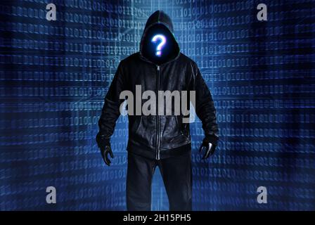 Photo of hacker person in black hood and clothing on digital binary code background. Stock Photo
