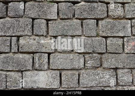 Photo texture of old and ancient gray colored stone wall. Stock Photo