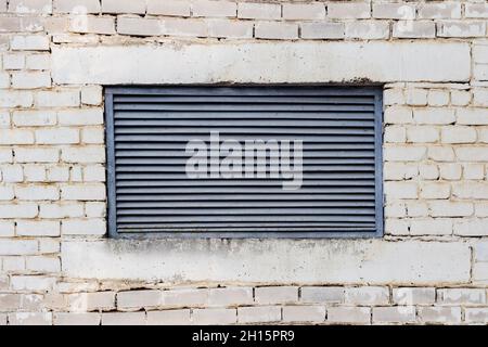 Photo texture of old ventilation metal hatch on brick wall. Stock Photo
