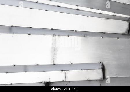 Texture photo of stainless steel armored black and white scratched surface plates. Stock Photo