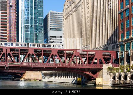 Commuter train crosses one of the bridges over the South Branch of the Chicago River in downtown Chicago Stock Photo