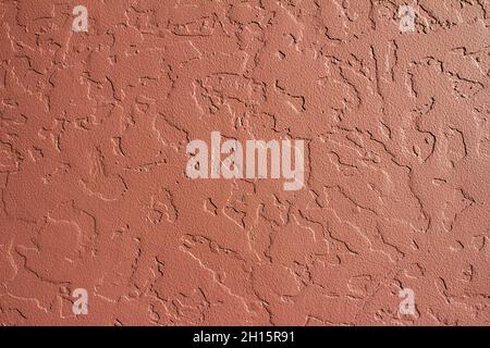 Photo texture of red colored decorative concrete wall stucco. Stock Photo