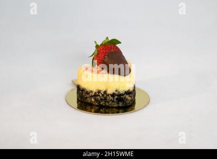 Creamy mango chocolate delicious mini cake with strawberry on the table on white background Stock Photo