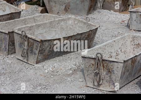Empty cement mortar in construction tanks. Construction site. Construction equipment. Bricks Stock Photo