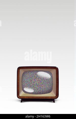 An old fashion television on a white background with static noise on the screen. Stock Photo