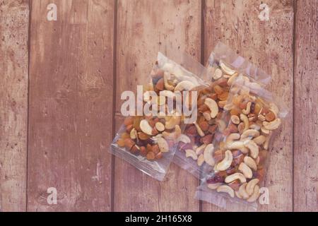 packet of mixed nuts on wooden background  Stock Photo