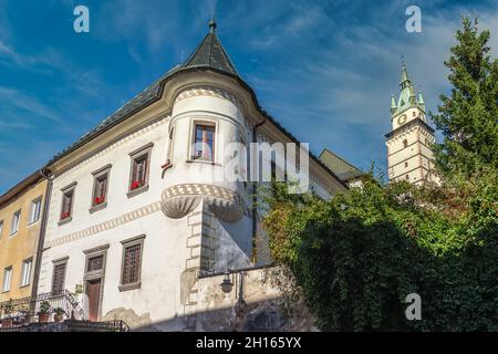 Renaissance mansion in Kremnica with turret like tower in the city of gold in Slovakia with imposing castle church bell tower in the background Stock Photo