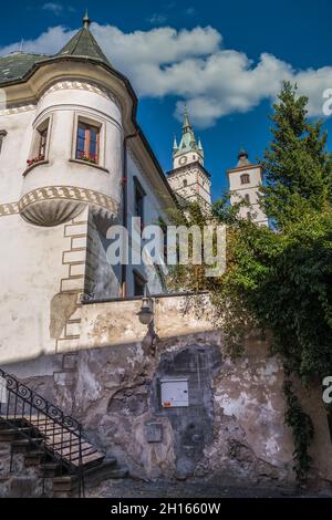 Renaissance mansion in Kremnica with turret like tower in the city of gold in Slovakia with imposing castle church bell tower in the background Stock Photo