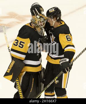 Pittsburgh Penguins goaltender Tristan Jarry (35) celebrates the 5-2 win against the Chicago Blackhawks Pittsburgh Penguins defenseman John Marino (6) at PPG Paints Arena in Pittsburgh on Saturday, October 16, 2021.  Photo by Archie Carpenter/UPI Stock Photo