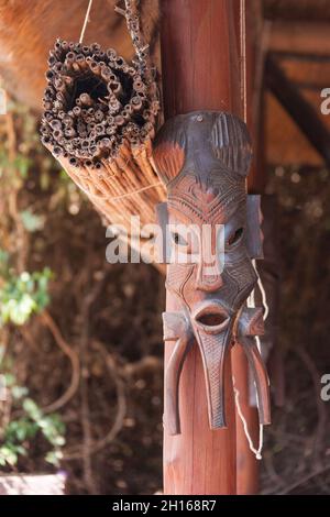 Sculpture of African mask hanging on the veranda Stock Photo