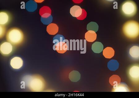 Holiday Christmas glowing color lights with sparkles, blurred bright Christmas abstract bokeh Stock Photo