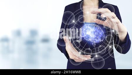 Science and artificial intelligence technology, innovation and futuristic. Two hand holding virtual holographic Brain icon with light blurred backgrou Stock Photo