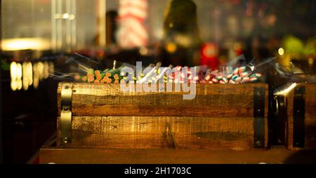 Colorful bright candy marmalade in a wooden box on the counter behind the glass. Stock Photo