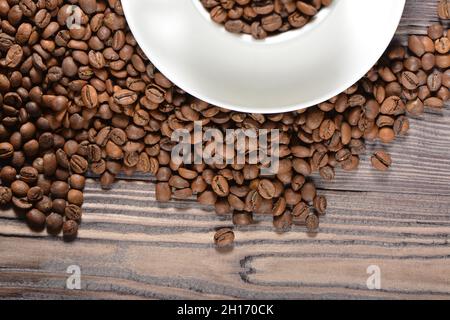 White coffee mug filled with coffee beans Stock Photo
