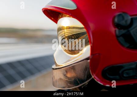 Unrecognizable firefighter wearing protective hardhat and special uniform with yellow reflective patches on background of clear sky in daytime Stock Photo