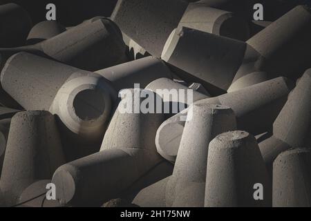 A grayscale shot of stone tetrapods on the beach during the beach Stock Photo