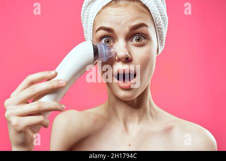 woman with towel on head cleaning skin therapy cosmetics technology Stock Photo