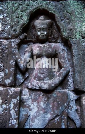 Sculpture carving figure apsaras or apsara angel deity female spirit of clouds waters and superb art of dancing in Prasat Ta Prohm or Ancestor Brahma Stock Photo