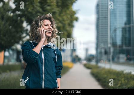 Young woman using mobile phone in the city Stock Photo