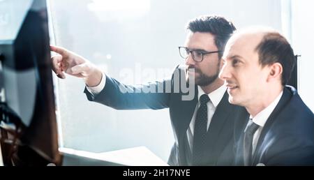 Business team analyzing data at business meeting in modern corporate office. Stock Photo