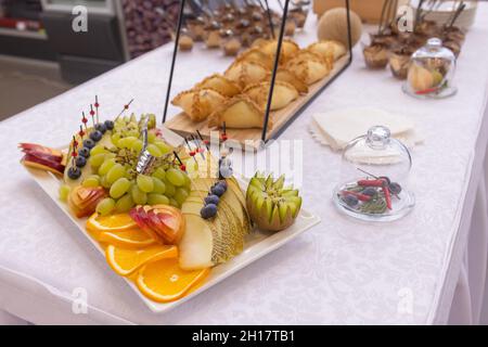 Different types of canapes on buffet table Stock Photo