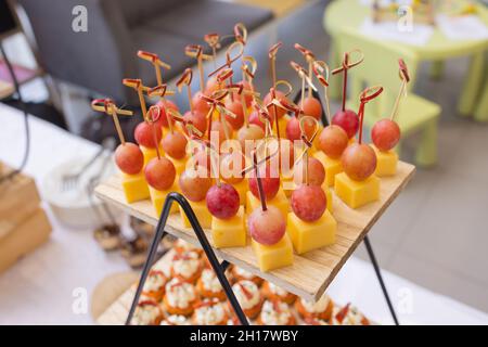 Different types of canapes on buffet table Stock Photo