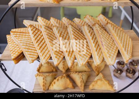 Different types of canapes on buffet table Stock Photo