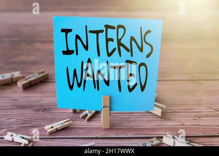 Text sign showing Interns Wanted. Business approach Looking for on the job trainee Part time Working student Blank Square Note Surrounded By Laundry Stock Photo