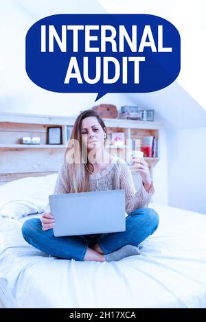 Hand writing sign Internal Audit. Internet Concept Evaluates the effectiveness of the controls and processes Reading Interesting Articles Online Stock Photo